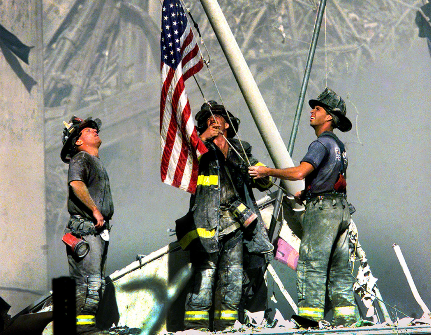 [Firefighters raising the American flag after the 9/11 attacks]